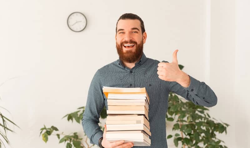 images/blogs/contentImages/portrait-smiling-office-worker-holding-many-books-showing-thumb-up (1).jpg